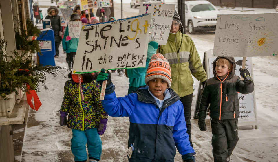 Radically inclusivecropped children holding signs while they march
