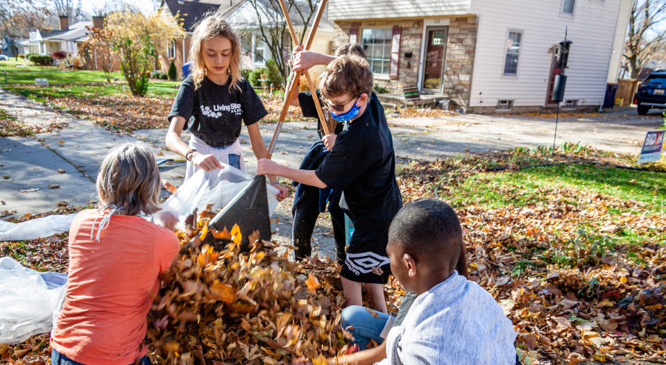 the world needs living stones kids raking leaves