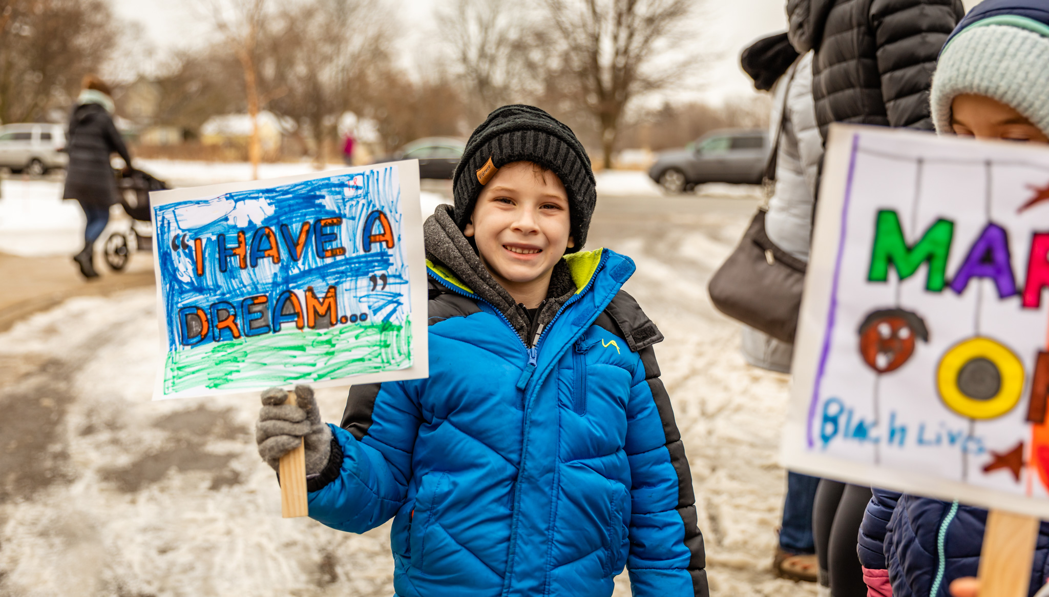 children holding signs while they march